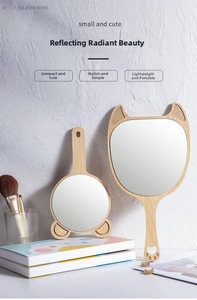 Detail of wooden handheld mirrors with cute cat and bear ear designs in a Nordic style