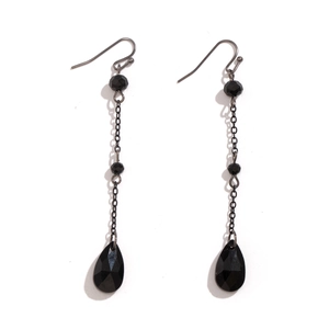 Macro shot of gothic black multifaceted teardrop crystal earrings with long tassel chain