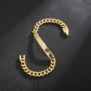 Macro shot of gold-plated stainless steel Cuban link bracelet with Roman numeral plate