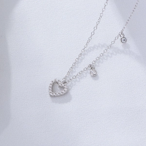 Close-up of S925 silver hollow heart pendant with sparkling cubic zirconia on a fine chain