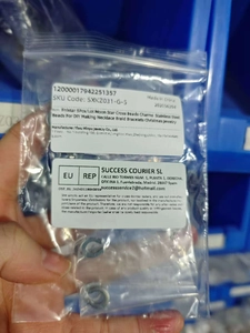 Detailed view of 5pcs stainless steel star and moon charms in transparent packaging