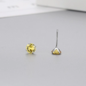 Macro shot of S925 sterling silver studs with yellow zircon in 4-prong setting