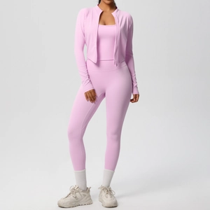 Detailed view of pink three-piece workout set including zipper jacket and yoga pants