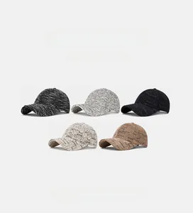 Detail showing five assorted baseball cap styles in neutral colors and patterns