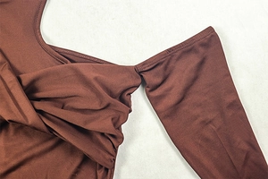 Detailed view of dark brown ruched shoulder design with elegant twist knot craftsmanship