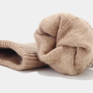 Macro shot of thick fleece lining and ribbed cuff on light camel thermal knit leg warmers