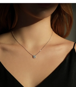 Detail of s925 sterling silver square moissanite necklace on female model neck