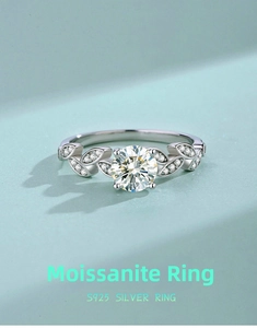 Detail of S925 silver moissanite ring with olive leaf design and pave-set diamonds