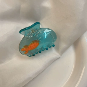 Blue aquarium style hair claw clip featuring a swimming orange fish and water bubbles