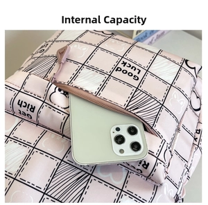 Detailed view of pink plaid backpack front pocket showing large capacity for smartphones
