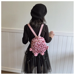 Rear view of a child wearing a mini pink leopard print plush backpack with cute ear details
