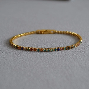 Golden tennis bracelet featuring colorful Mediterranean style candy gems and folding clasp