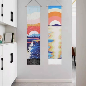 Detail of dual landscape wall tapestries with sunset motifs and decorative fringe accents