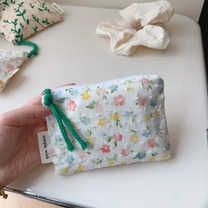 Detailed close-up of floral cotton pouch showing 3D texture and simple wish woven label