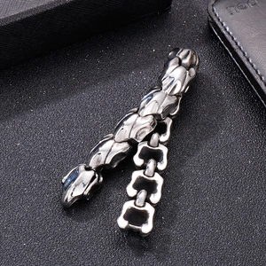 Vintage stainless steel dragon bone chain bracelet for men on black textured background