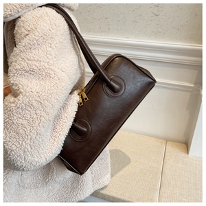 Detailed macro of dark brown PU leather shoulder bag with smooth texture and gold zipper