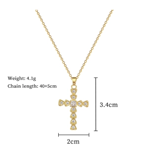 Detail view of gold cross necklace with clear gems showing size and 4.1g weight specs