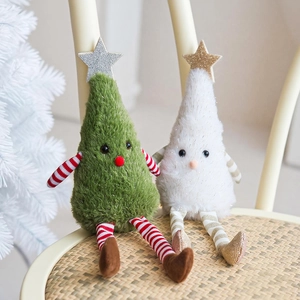Cute plush Christmas tree dolls with striped legs sitting on a wooden chair