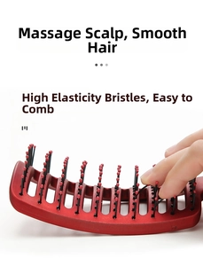 Detail showing highly elastic hairbrush bristles and red massage tips being pressed