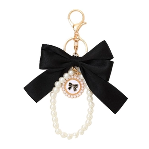 Elegant black bow keychain with pearls and gold hardware for phone case decoration