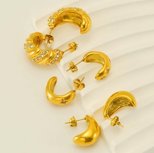 Detailed view of three 18k gold plated stainless steel stud earrings with zircons