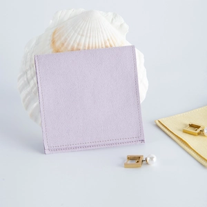 Detail of purple velvet jewelry pouch with pearls and shell in an elegant setting