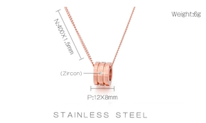 Macro shot of rose gold stainless steel necklace with zircon pendant and size dimensions