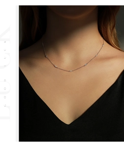 Detail of s925 silver choker necklace with sparkling diamonds on a female model