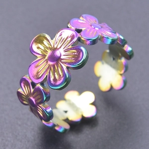 Detail of adjustable floral ring with rainbow colorful finish in stainless steel