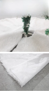 Detail of white plush Christmas tree skirt showing high-density faux fur and opening design