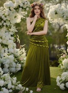 Detail of olive green velvet dress featuring a unique twisted shoulder and woven texture