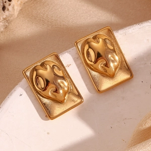 Macro shot of gold-plated rectangular earrings with 3D abstract embossed liquid textures