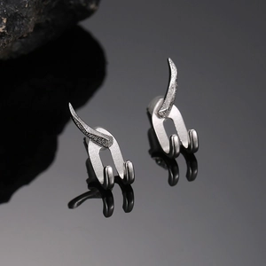 Minimalist punk style silver curved hook earrings with sleek metallic finish in a pair