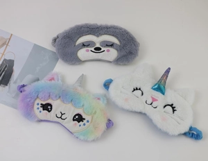 Detail of plush cartoon eye masks in sloth, cat and unicorn designs with soft texture
