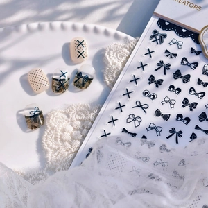 Minimalist black and white bow nail stickers featuring polka dots and crisscross lines