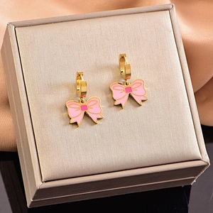 Chic pink enamel bow hoop earrings with gold finish on a premium jewelry box