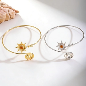 Detailed close-up of retro sunburst arm cuffs with turquoise center and spiral metal wire