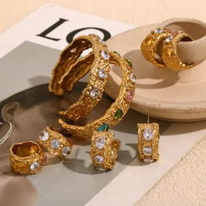 Vintage 18K gold plated jewelry set with textured hammered metal and colorful gemstones
