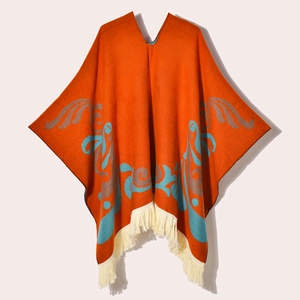 Boho vintage orange knit poncho with floral patterns and fringe trim for women