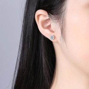 Classic round moissanite stud earring with halo diamonds on a silver metal base