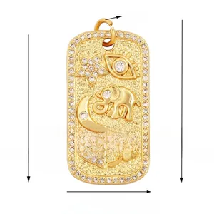 Detailed view of a gold-plated rectangular charm with embossed evil eye and star patterns