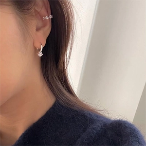 Detail of 925 sterling silver hoop earring with pendant and paved zircon ear cuff