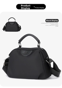 Close-up of waterproof nylon handbag with leather handles and adjustable shoulder strap