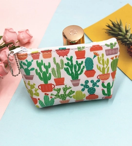 Detail of a trapezoid cactus print coin purse with silver chain on colorful background