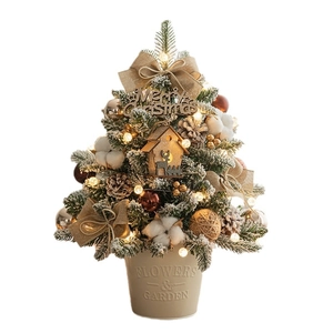 Mini DIY Christmas tree in beige pot with warm LED lights, pine cones and rustic ornaments