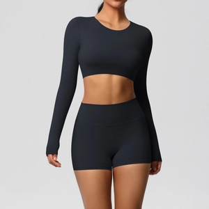 Detail of black brushed yoga set featuring long sleeve crop top and high waist sports shorts