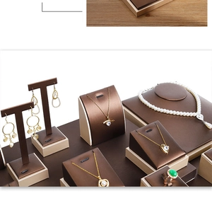 Detail of premium brown and champagne gold jewelry display set for necklaces and rings