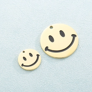 Titanium steel smiley face necklace pendants in two sizes with gold finish on blue background