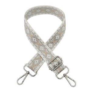 Detail of adjustable woven bag strap with geometric jacquard pattern and silver buckle