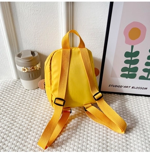 Rear view of yellow little duck backpack showing nylon straps and adjustable black buckles